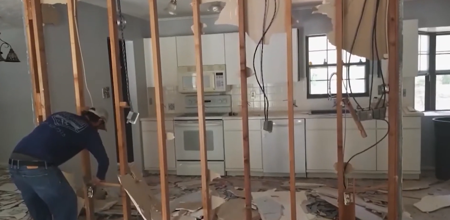New plumbing rough-in through open framing in a gutted kitchen