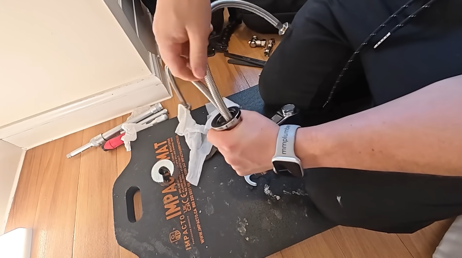Cutting into a pipe at floor level beside a baseboard