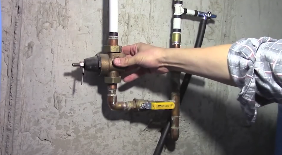 Brass isolation valves and fittings on an exterior wall supply line