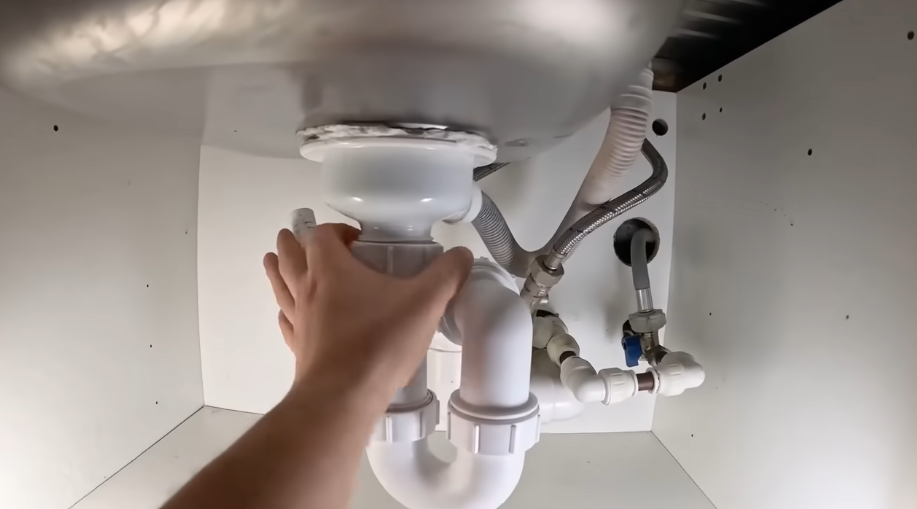 Fitting a garbage disposal and sink drain assembly in an under-sink cabinet