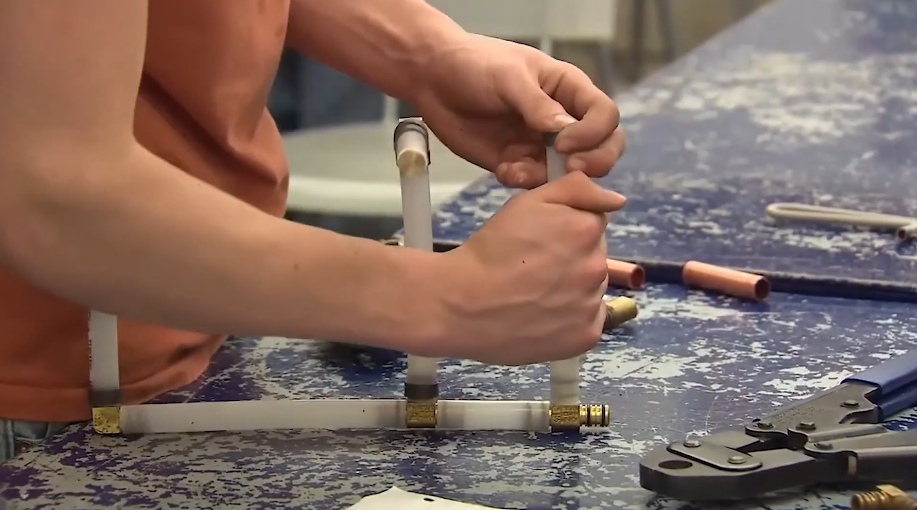 Assembling threaded brass gas fittings at a bench