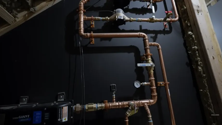 Copper water heater supply piping with shutoff valves on a utility wall in a Tustin Ranch home